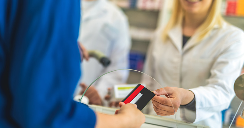 PERSON PASSING CREDIT CARD THROUGH WINDOW