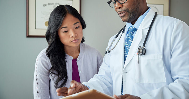 DOCTOR REVIEWING PAYMENT PLAN WITH PATIENT