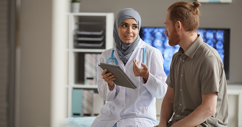 DOCTOR TALKING TO PATIENT WITH REDHAIR