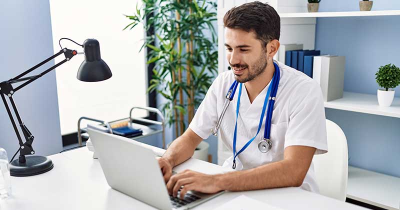 Doctor typing on laptop