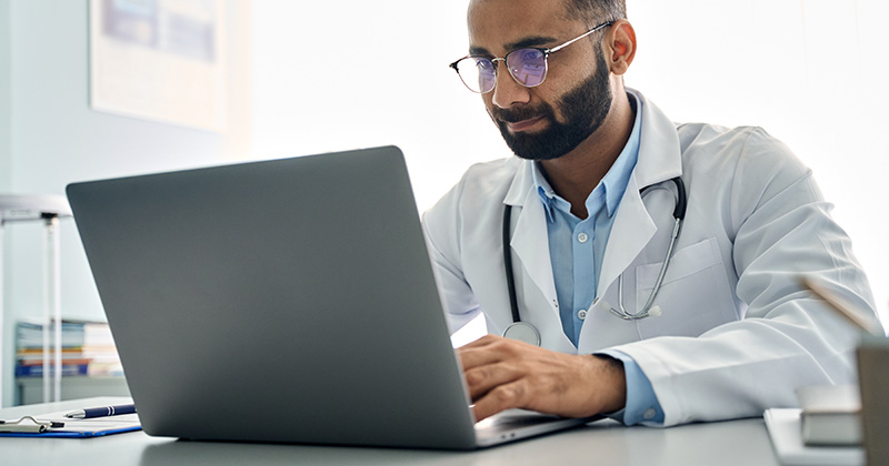 DOCTOR USING LAPTOP