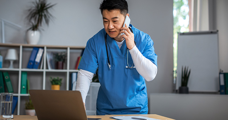 male doctor consults computer in cashless healthcare practice