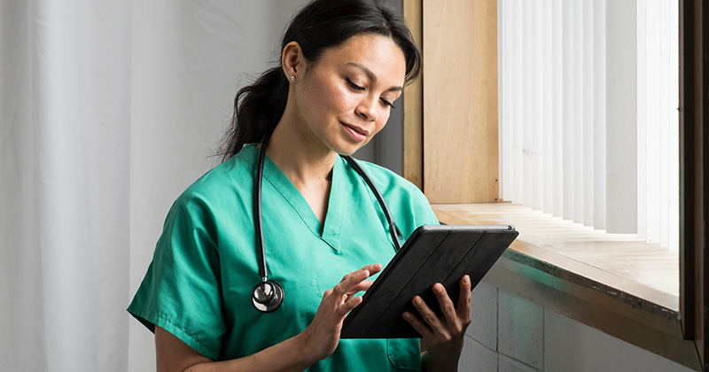 NURSE LOOKING AT IPAD