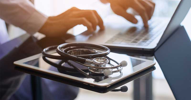 stethoscope with tablet and laptop