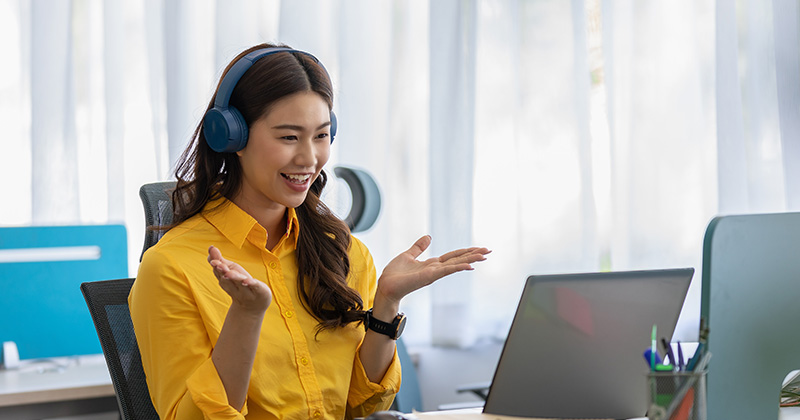 WOMAN IN YELLOW SHIRT WITH HEADPHONES